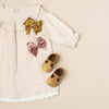 the original soft soled t-strap: gold shimmer