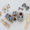 the original soft soled t-strap: distressed zebra suede