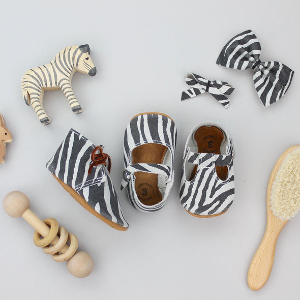 the original soft soled t-strap: distressed zebra suede