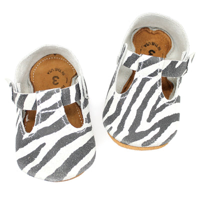 the original soft soled t-strap: distressed zebra suede